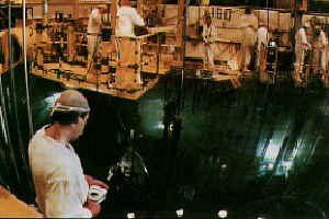 A health physicist checks the radiation levels above a reactor cavity pool in a commercial nuclear reactor